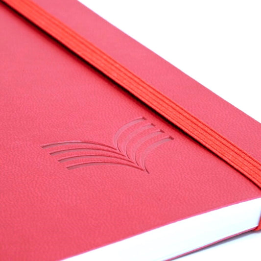 Close-up of a red notebook with a logo on a white background